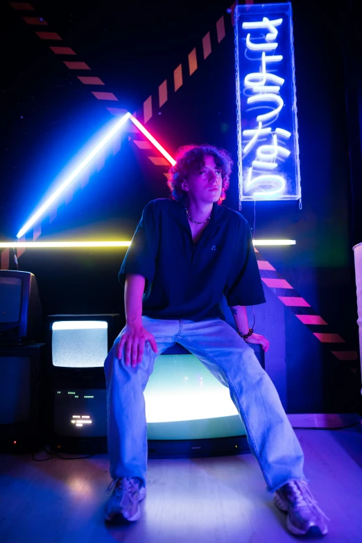 a man sitting on top of a tv in a room, an album cover, inspired by Eugene Leroy, unsplash, 8 0 s asian neon movie still, standing in a server room, casual pose, l · lawliet