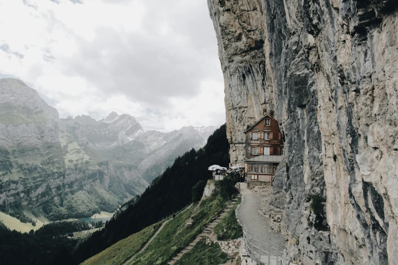 a house sitting on the side of a cliff, by Johannes Voss, pexels contest winner, renaissance, restaurant, suzanne engelberg, herzog de meuron, portait photo