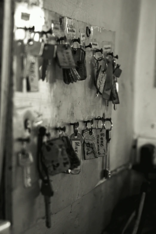a bunch of keys hanging on a wall, a black and white photo, by Gang Hui-an, happening, vendors, locker room, display”, marker”