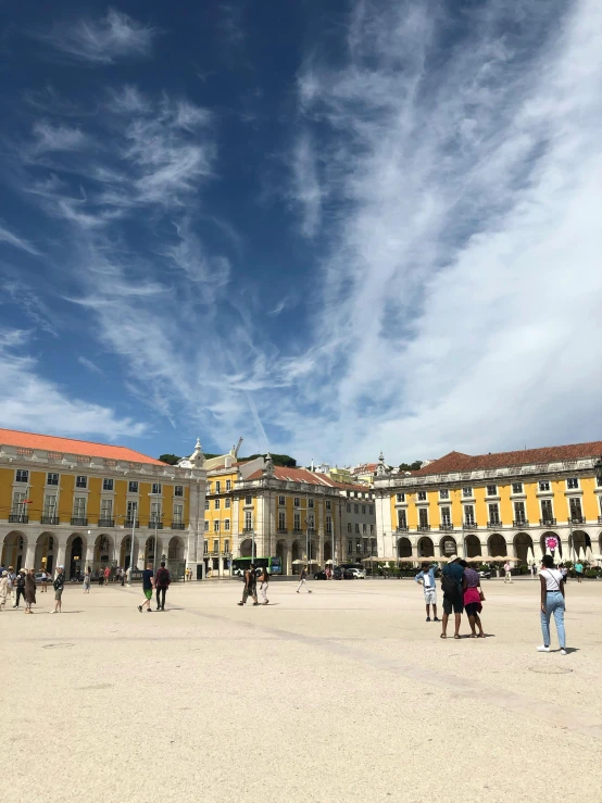 a group of people walking around a plaza, by Tom Wänerstrand, pexels contest winner, neoclassicism, blue skies, lisbon, iphone photo, 🚿🗝📝