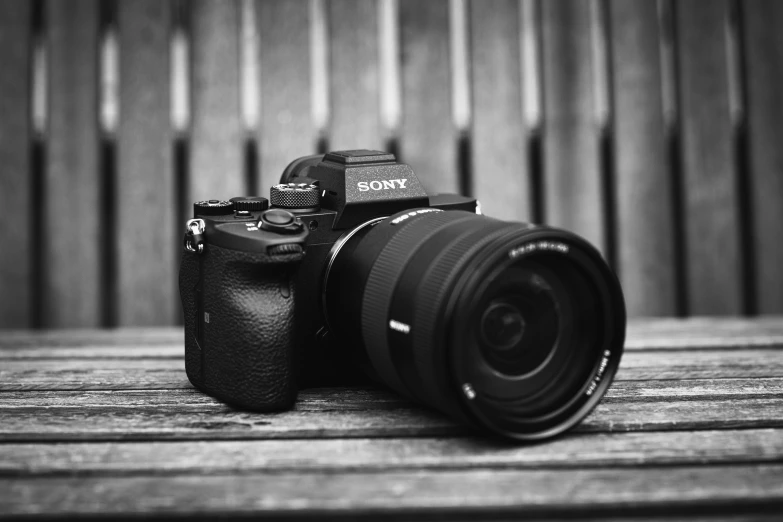 a camera sitting on top of a wooden table, a picture, sony a 7 siii, macro lens product photo, bw photo, 8k))