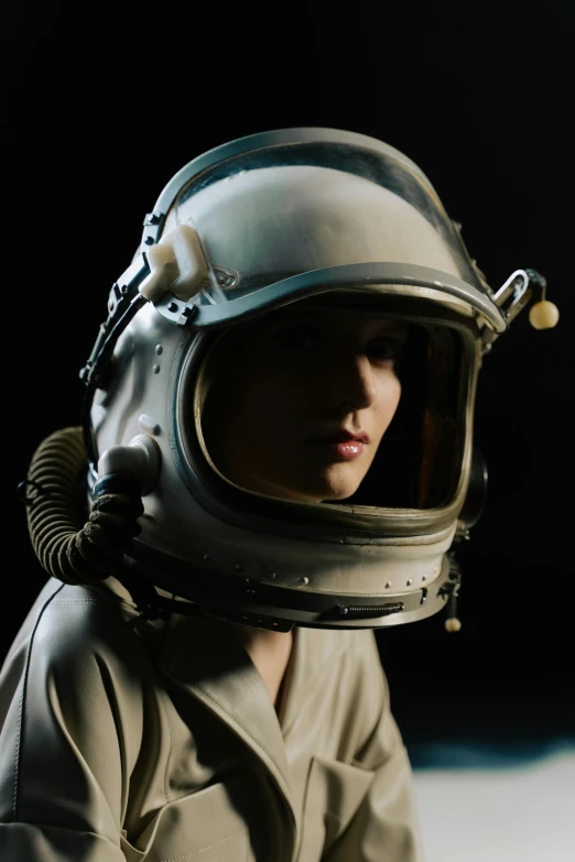 a close up of a person wearing a helmet, unsplash, fantastic realism, 1 9 6 0 s space girl, studio photo, (night), modest