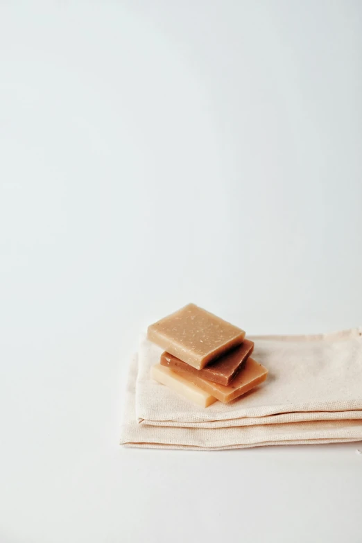 a stack of food sitting on top of a white table, a picture, wet fabric, caramel. rugged, gum tissue, thumbnail