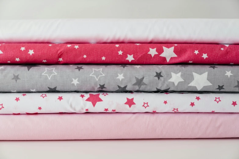 a stack of pink, grey and white stars, red fabric, moonlight grey, heaven pink, stargazer