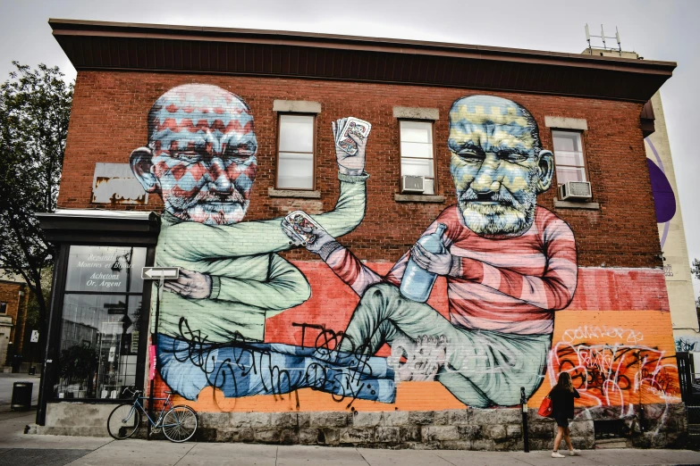 a mural of two men on the side of a building, graffiti art, pexels contest winner, quebec, klee, two old people, 🚿🗝📝