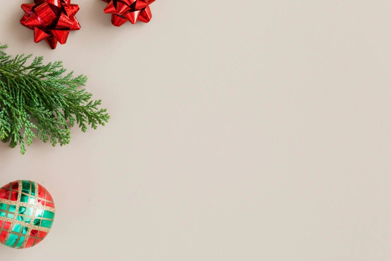 a close up of a christmas ornament on a table, trending on pexels, minimalism, background image, light - brown wall, red green, evergreen