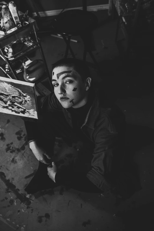 a black and white photo of a man sitting on the floor, a charcoal drawing, inspired by Taro Yamamoto, tumblr, serial art, portrait of florence pugh, mime, warpaint aesthetic, androgynous vampire