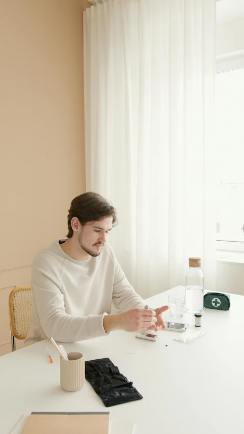 a man sitting at a table in front of a computer, clean aesthetic, holding a bottle, profile image, swedish