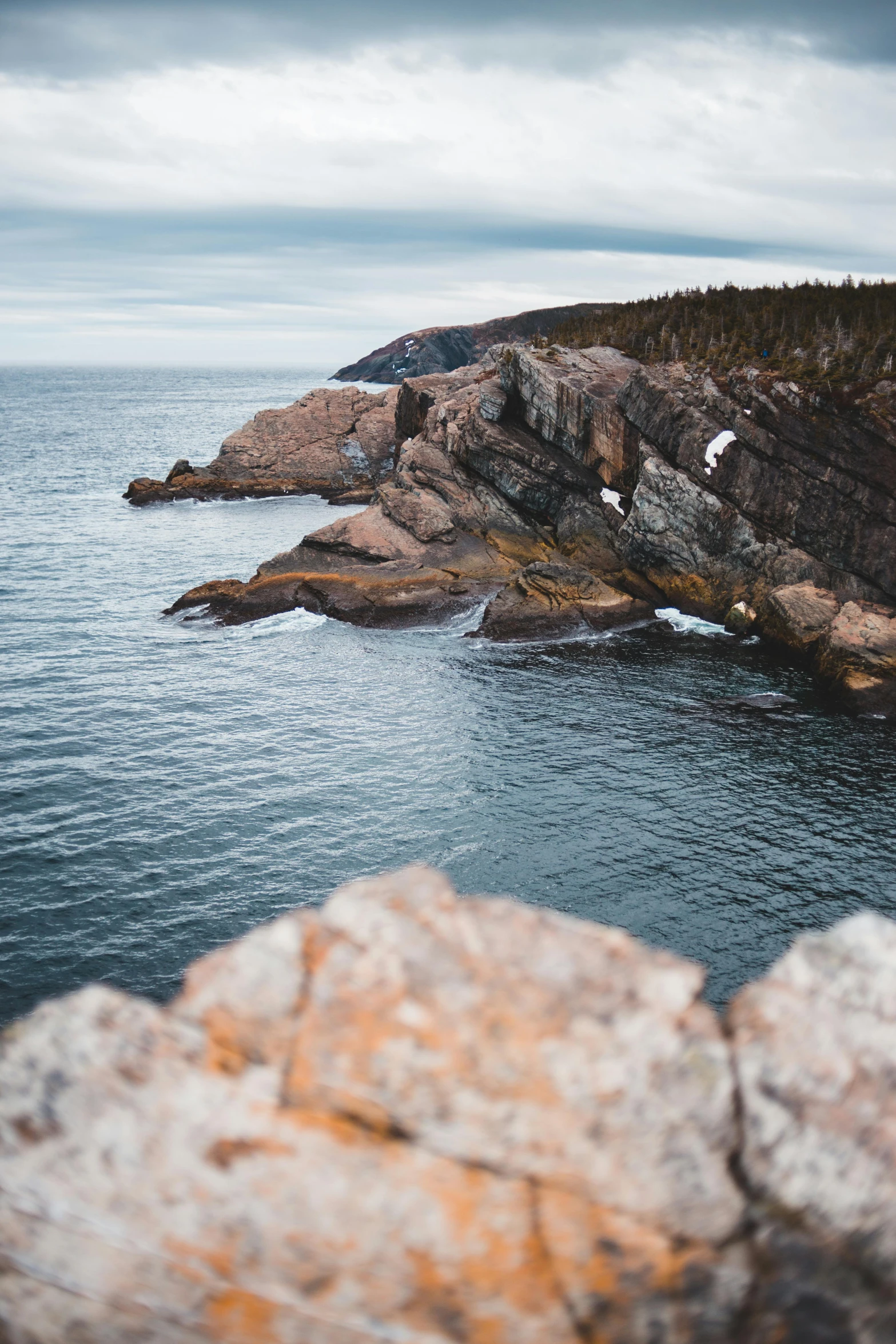 a large body of water next to a rocky shore, by Bascove, pexels contest winner, les nabis, francois legault, slide show, 7 0 mm photo, multiple stories