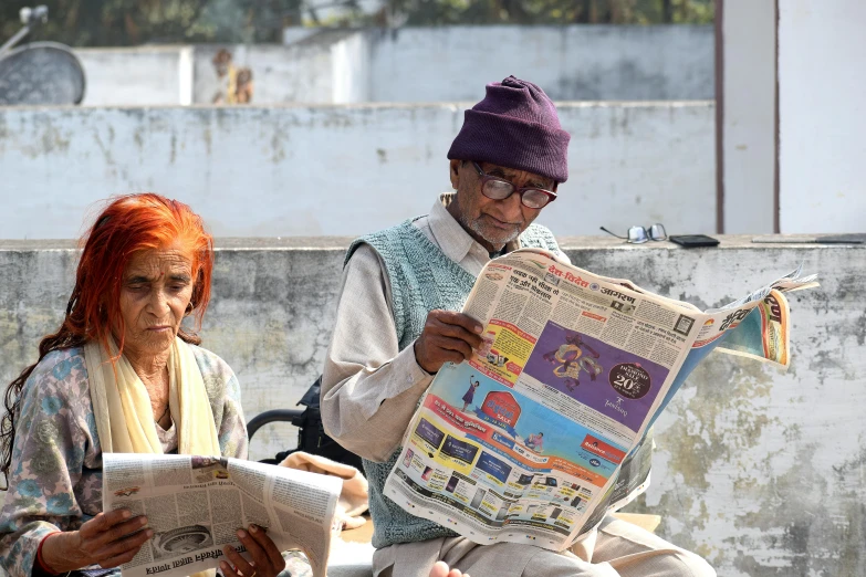 a man and a woman sitting on a bench reading a newspaper, pexels contest winner, private press, uttarakhand, two old people, civ ghandi, on a sunny day