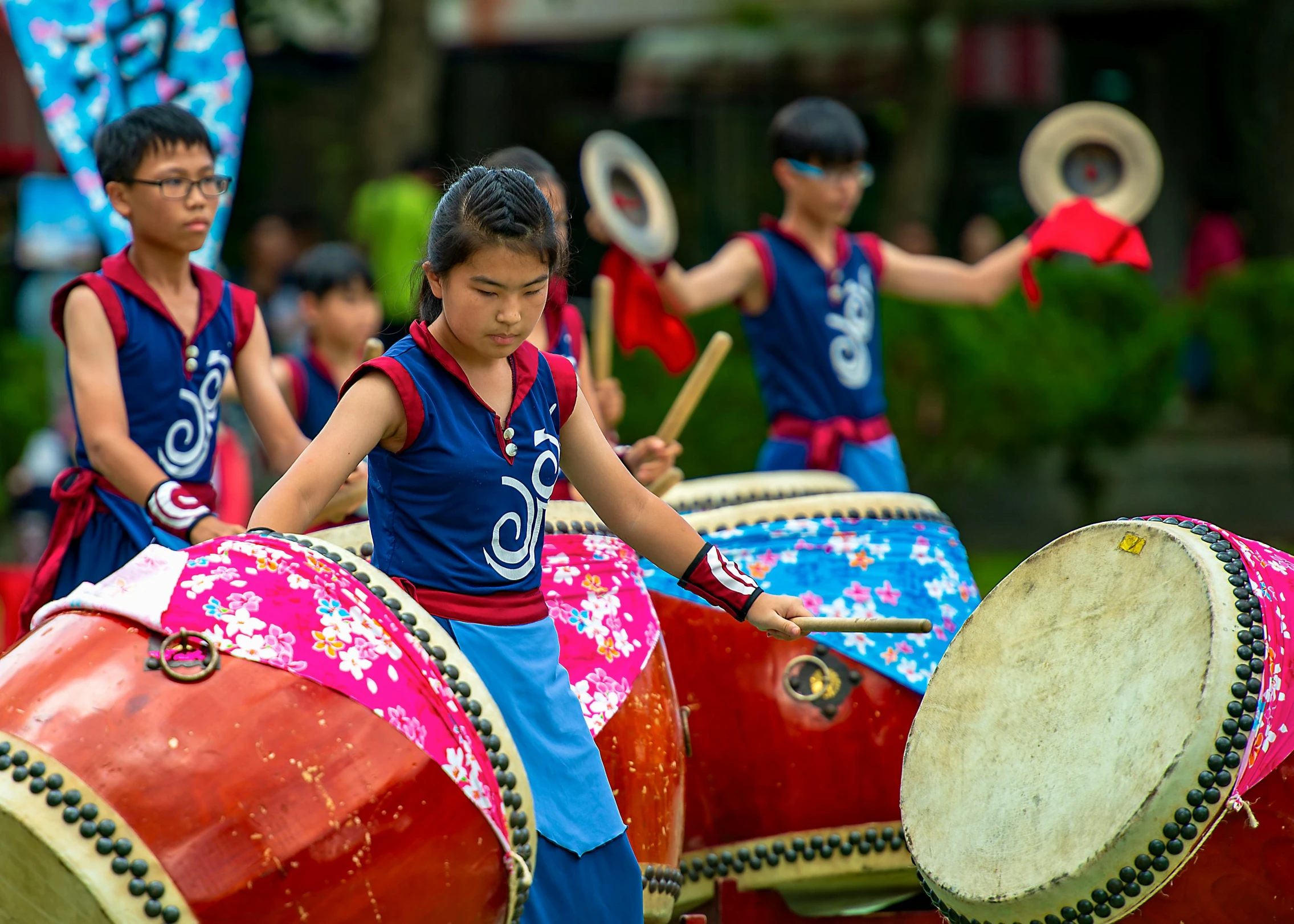 a group of children playing drums in a park, inspired by Miao Fu, pexels contest winner, cloisonnism, avatar image, parade floats, jakarta, ethnicity : japanese