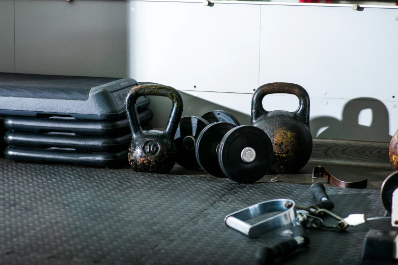 a couple of kettle weights sitting on top of a floor, private press, curvy crossfit build, various items, metal works, profile image