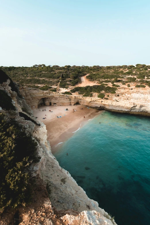 a large body of water next to a sandy beach, by Lucas Vorsterman, pexels contest winner, apulia, trees and cliffs, wide high angle view, slide show