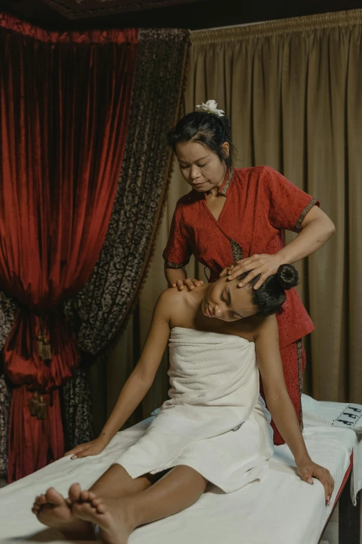 a woman getting a head massage at a spa, a portrait, by Basuki Abdullah, layed on a red velvet fabric, thumbnail, movie still, petite