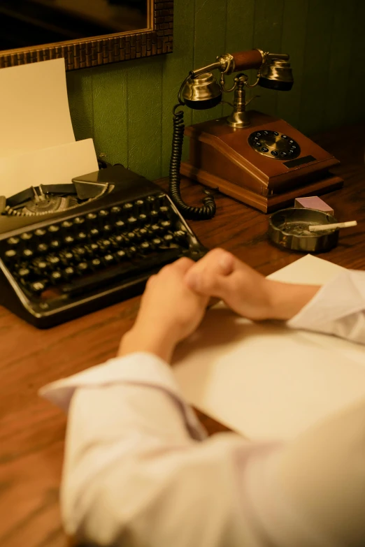 a man sitting at a desk in front of a typewriter, unsplash, private press, the grand budapest hotel, background image, evening time, thumbnail