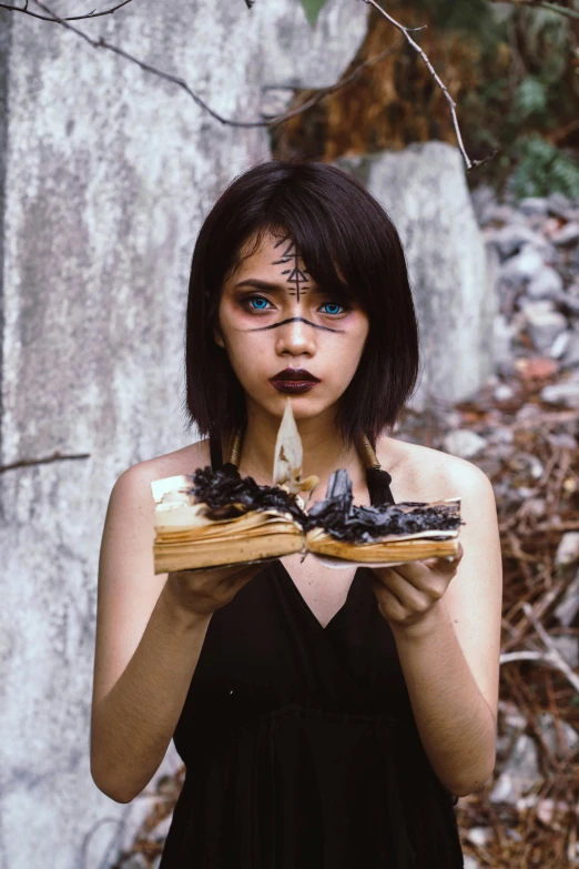 a woman holding a piece of wood in front of her face, an album cover, pexels contest winner, surrealism, holding spell book, with haunted eyes and dark hair, cosplay photo, profile image