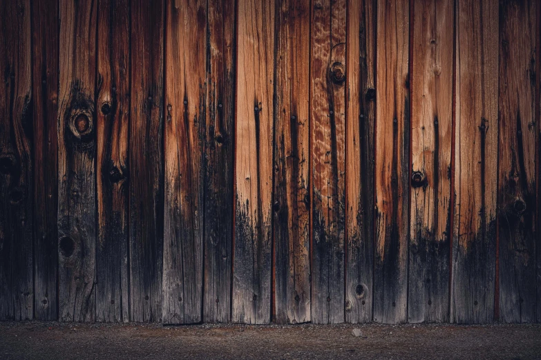 a red fire hydrant sitting in front of a wooden wall, unsplash, renaissance, background image, dark grey and orange colours, wood planks, alessio albi