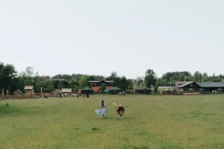 a man riding a horse across a lush green field, by Emma Andijewska, unsplash, land art, russian village, random cows, panoramic view of girl, adventure playground