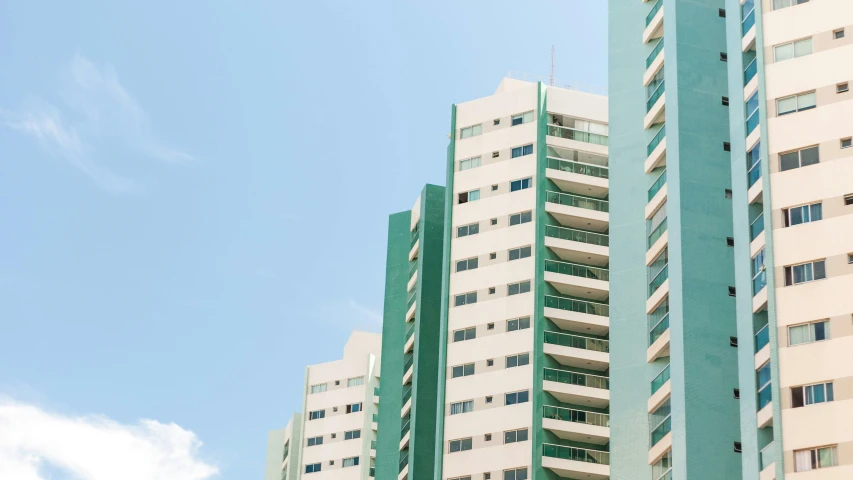 a couple of tall buildings sitting next to each other, by Carey Morris, pexels contest winner, brutalism, white and teal metallic accents, in sao paulo, a green, clemens ascher