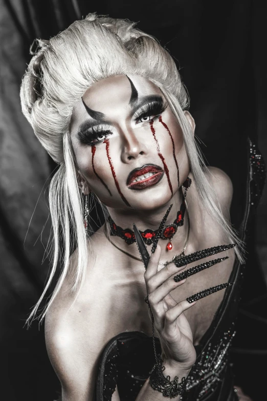 a black and white photo of a woman with blood on her face, an album cover, inspired by Lam Qua, trending on pexels, ru paul\'s drag race, fit male demon with white horns, andrew thomas huang, 2 0 0 0's photo