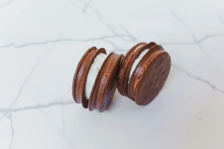 a couple of cookies sitting on top of a table, product image, split in half, 2 1 mm, marshmallow