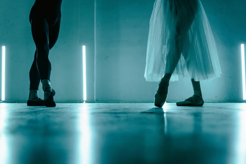 a couple of dancers standing next to each other, inspired by Elsa Bleda, light and space, ambient teal light, shows a leg, lee madgwick & liam wong, profile image