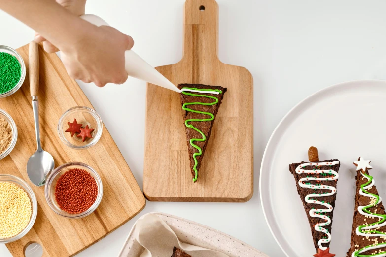 a person cutting a piece of cake on a cutting board, dunce, fully decorated, stroopwaffel, detailed product image