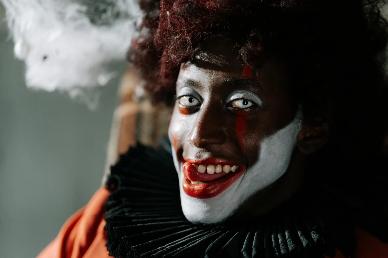 a close up of a person dressed as a clown, a portrait, pexels contest winner, renaissance, with brown skin, oozing black goo, mischievous look, ad image