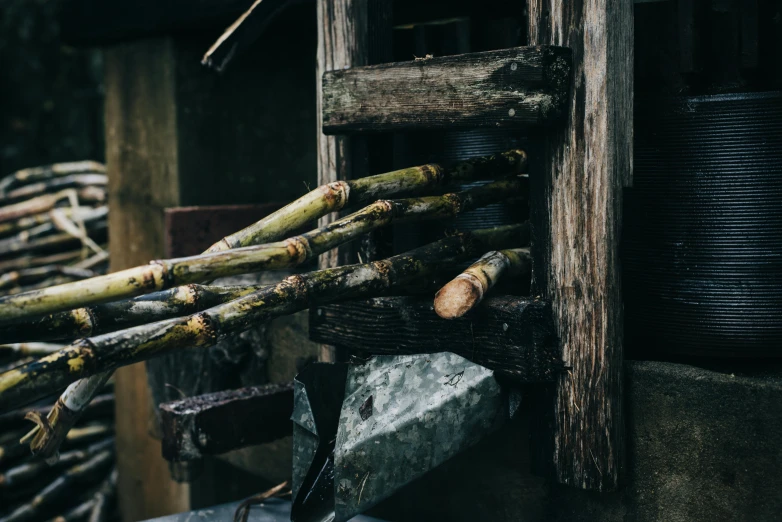 a pile of sticks sitting on top of a pile of rocks, unsplash, renaissance, working in the forge, asparagus, background image, mill