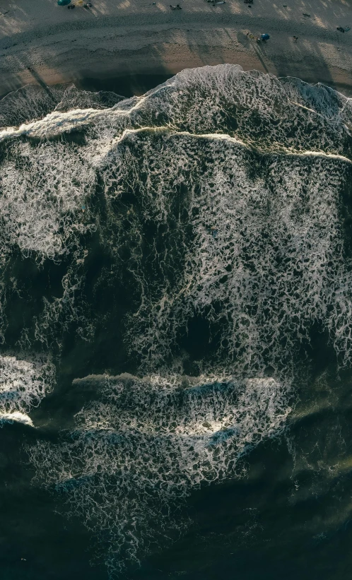 a man riding a surfboard on top of a wave, an ultrafine detailed painting, inspired by Andreas Gursky, trending on pexels, high resolution coal texture, microscopic view, cliffside, drone photo