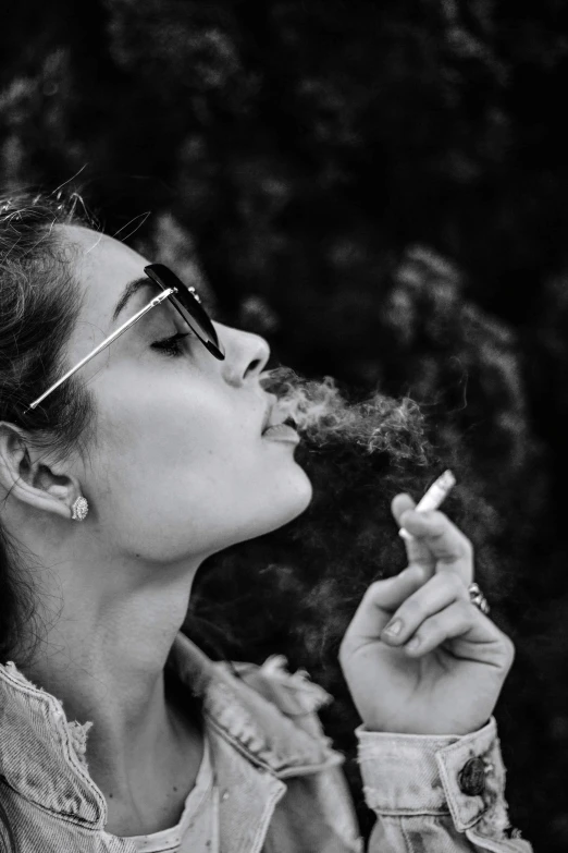 a black and white photo of a woman smoking a cigarette, a black and white photo, pexels contest winner, shades, ganja, profile pic, instagram post