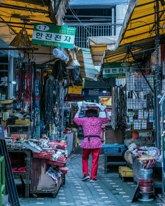 a woman in a pink jacket walking through a market, by Meredith Dillman, pexels contest winner, south korean male, square, neon shops, 2 0 2 2 photo