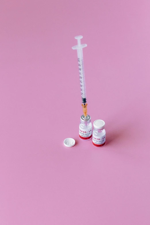 a syll sitting on top of a pink surface, pexels, syringes, iv pole, white and red color scheme, steroid use