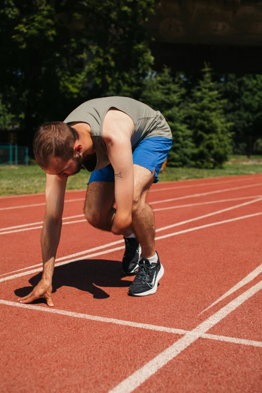 a man getting ready to run on a track, profile image