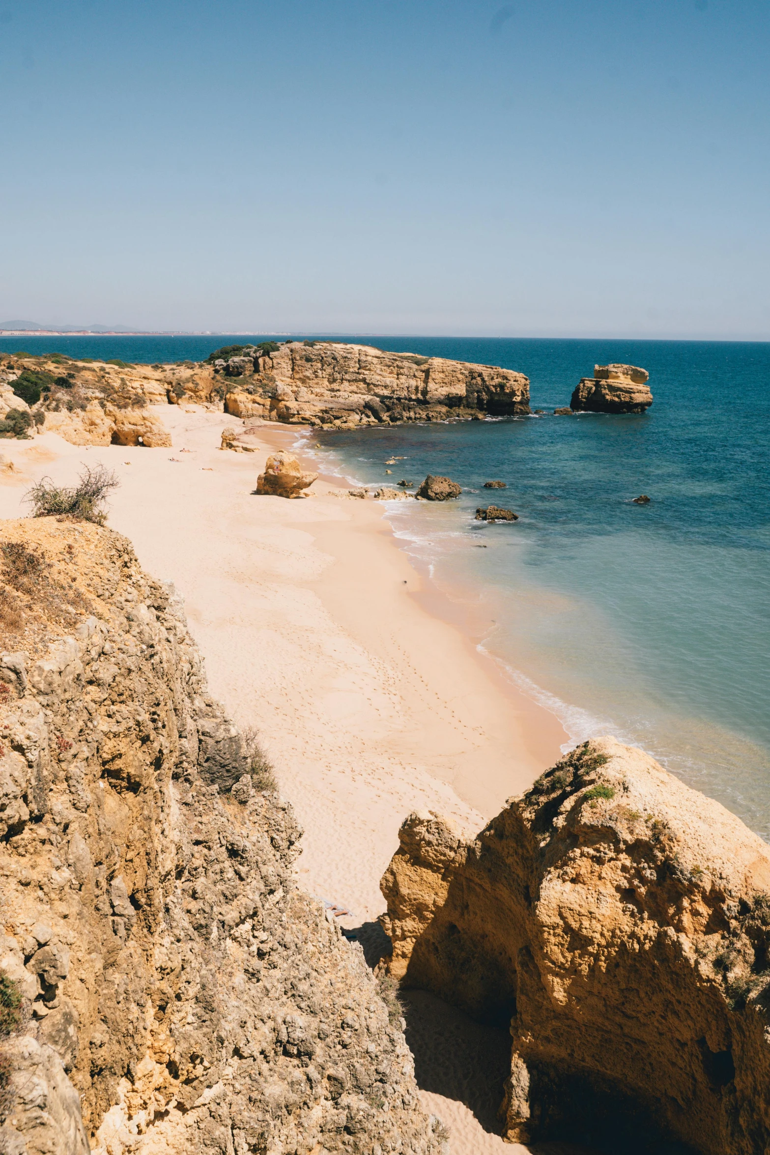 a sandy beach next to a body of water, renaissance, coastal cliffs, adreas rocha, reefs, exterior