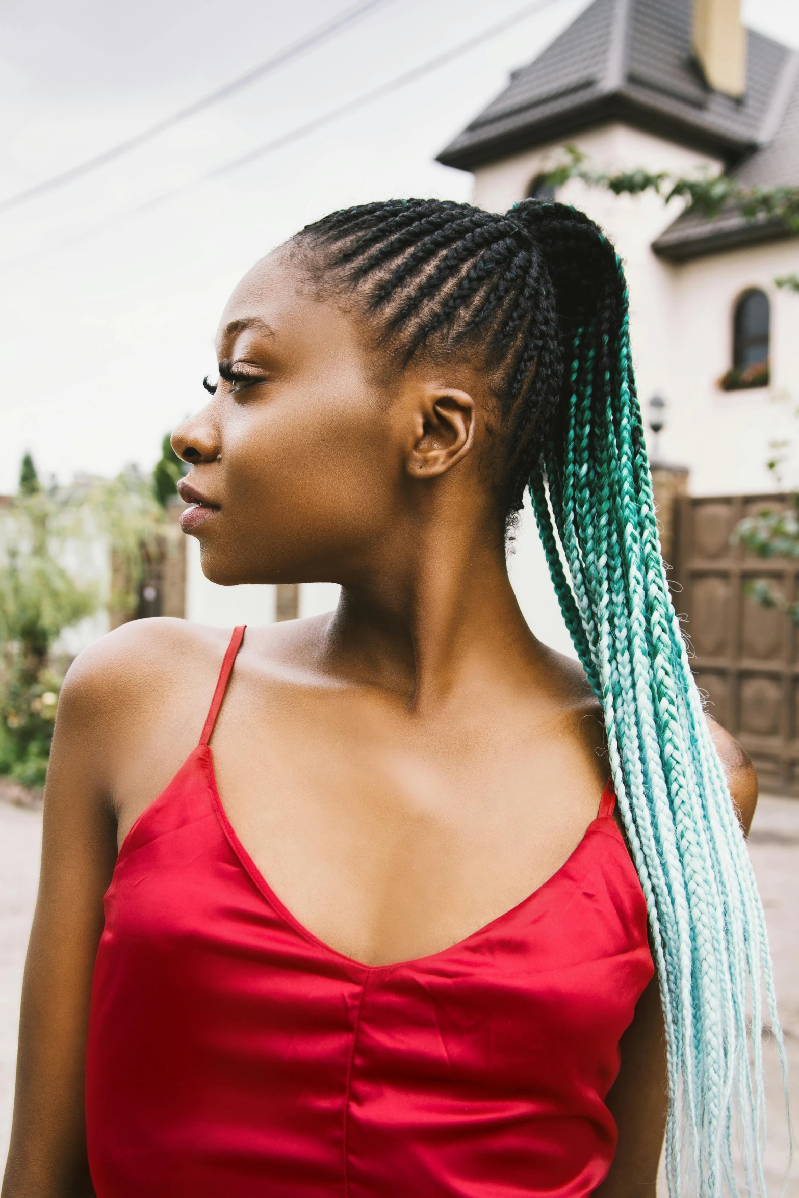 a woman with blue dreadlocks standing in front of a house, trending on pexels, renaissance, teal silver red, with a ponytail, african american young woman, ombre