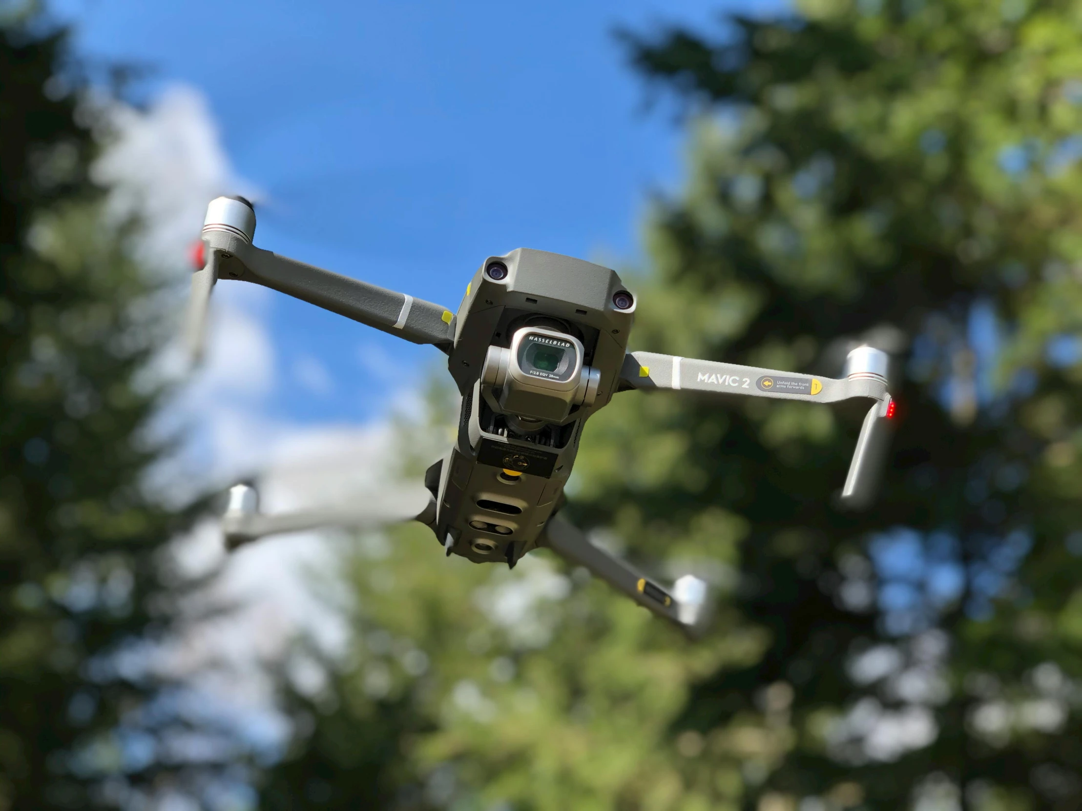 a close up of a small drone flying in the sky, a portrait, unsplash, plein air, boston dynamics, taken on iphone 1 3 pro, beautiful surroundings, 8k resolution”