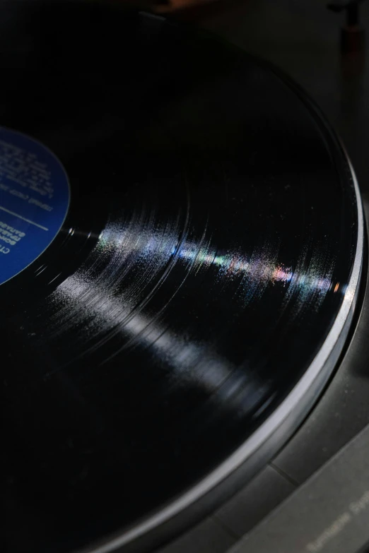 a close up of a record on a turntable, by Doug Ohlson, holography, on a gray background, promo image, high angle shot, high quality picture