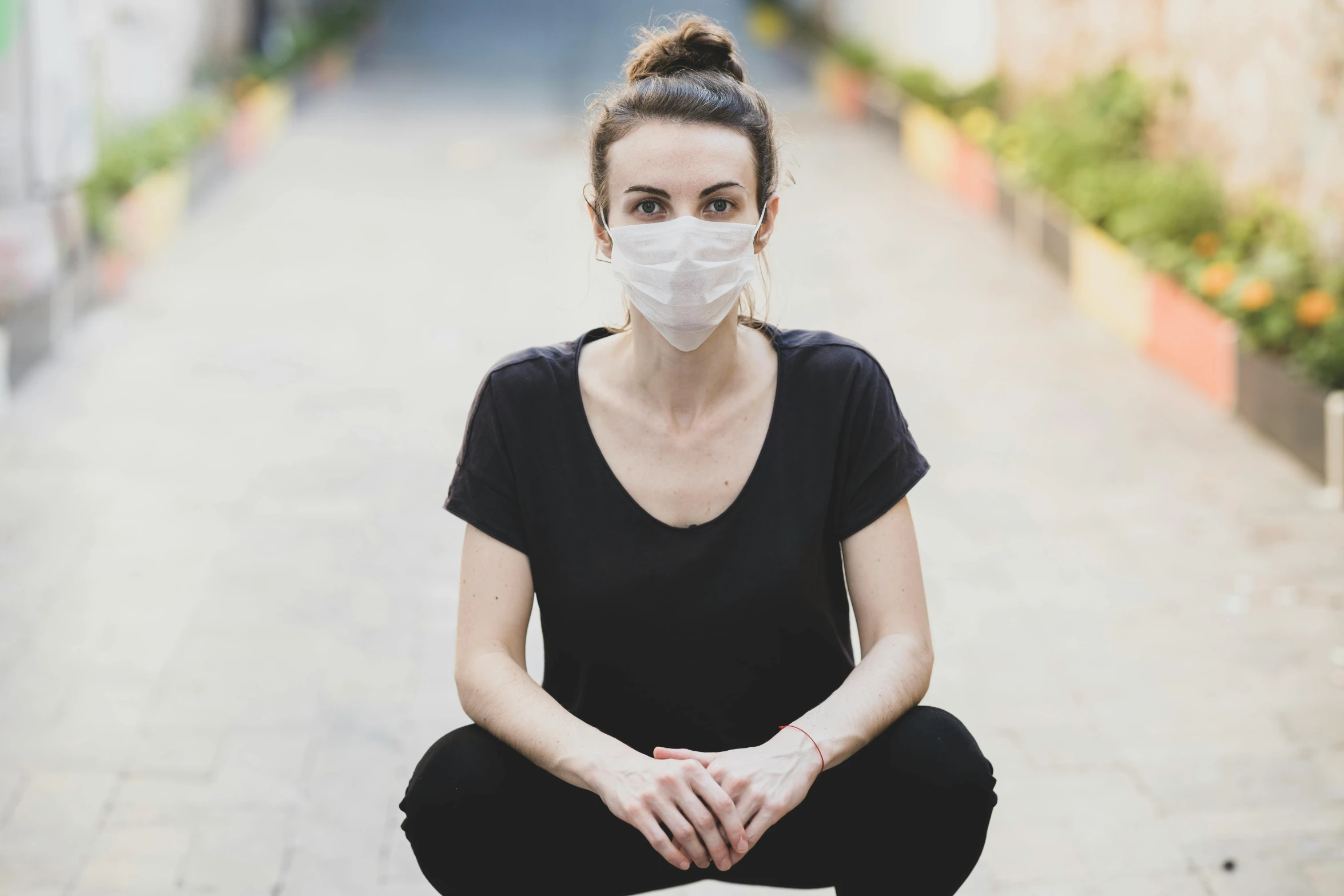 a woman sitting on the ground wearing a face mask, a picture, sanja stikovic, blank, portrait image, healthcare