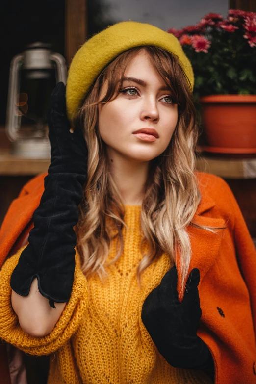 a woman in a yellow sweater and black gloves, by Julia Pishtar, trending on pexels, berets, sydney sweeney, attractive brown hair woman, anna nikonova aka newmilky