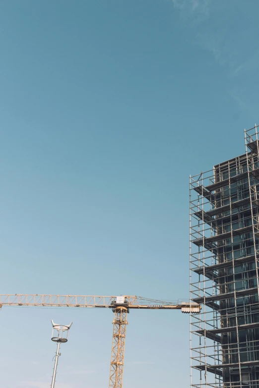 a building under construction with a lot of scaffolding, by Niko Henrichon, pexels contest winner, commercial banner, thumbnail, pastel', crane shot