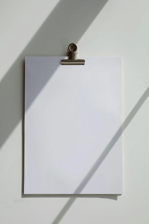 a clipboard sitting on top of a white wall, a poster, by Daniel Seghers, unsplash, visual art, back light, ilustration, soft shadow, up-close