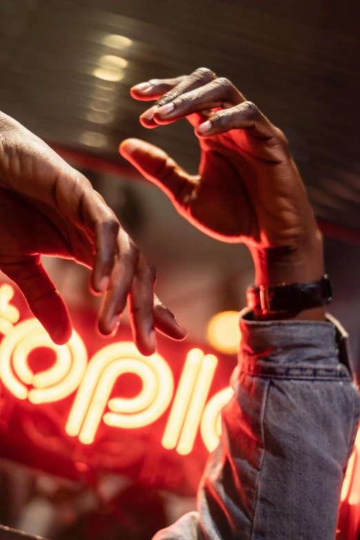 a man standing in front of a neon sign, an album cover, by Raphaël Collin, trending on unsplash, happening, hands reaching for her, 2 rappers on stage at concert, chillin at the club together, ripple