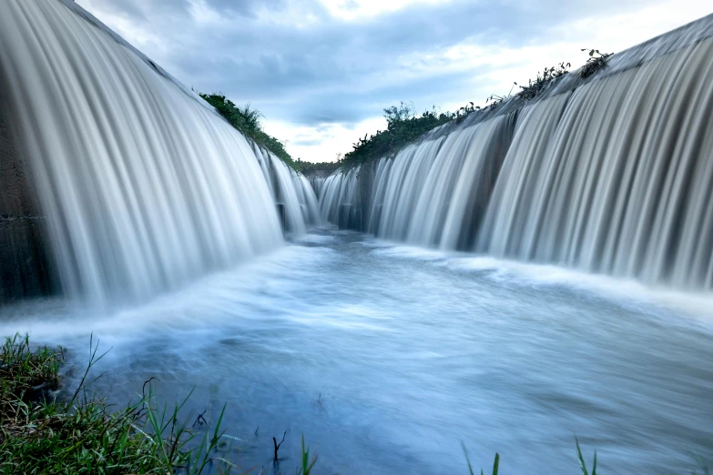 a large waterfall in the middle of a river, inspired by Pierre Pellegrini, unsplash contest winner, hurufiyya, detailed photo 8 k, irrigation, low - level view, taken in the late 2010s