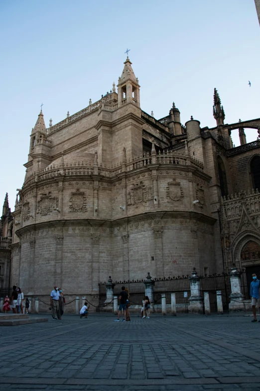 a group of people that are standing in front of a building, inspired by Eugenio de Arriba, baroque, huge support buttresses, mosque, with slight stubble, inside cathedral