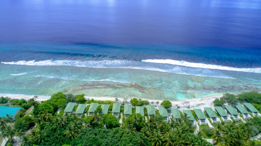 an aerial view of a resort in the middle of the ocean, by Daren Bader, hurufiyya, lush scenery, long view, kanamemo, twice