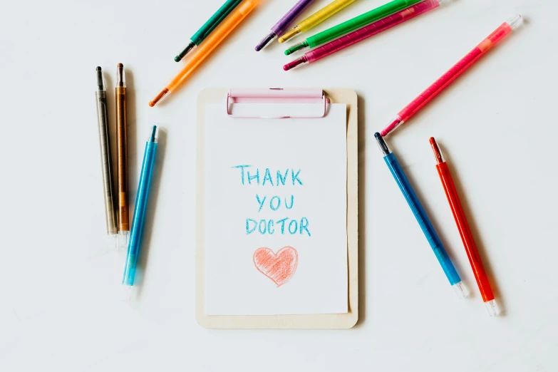 a clipboard with a thank you doctor written on it, a child's drawing, pexels contest winner, crayon art, instagram post, jovana rikalo, surgical supplies, wholesome