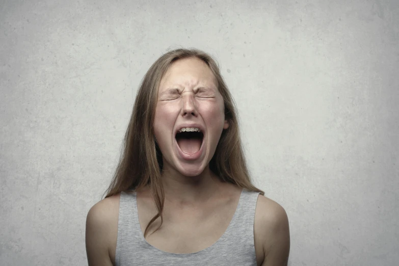 a woman making a funny face with her mouth wide open, pexels, screaming in pain, teenager girl, fine-art, people crying