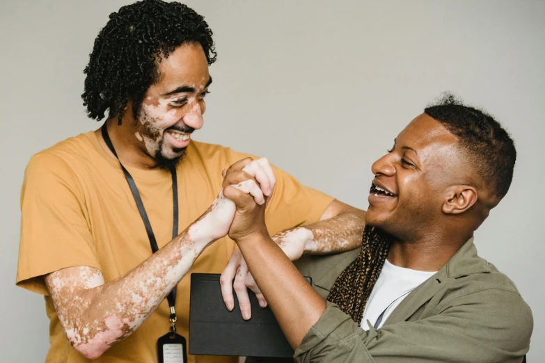 a couple of men standing next to each other, pexels contest winner, renaissance, arm wrestling, brown skin man with a giant grin, reaching out to each other, charli bowater and artgeem