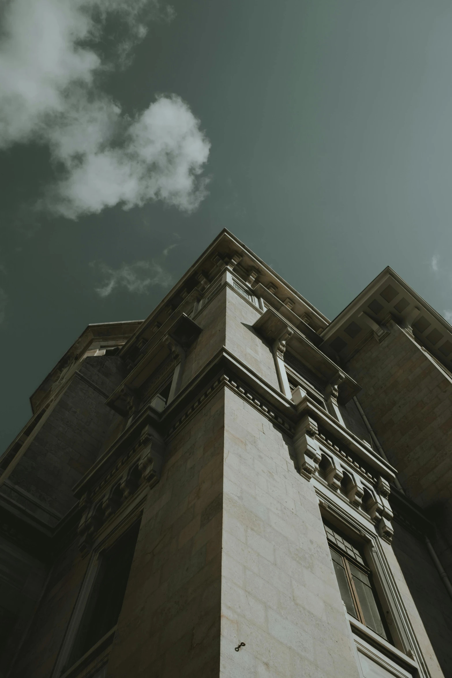 a tall building with a clock on top of it, pexels contest winner, neoclassicism, cinematic view from lower angle, gothic mansion, beige and dark atmosphere, looking left